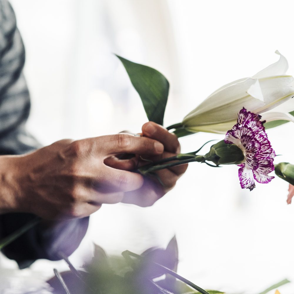 Young male florist working in flower shop